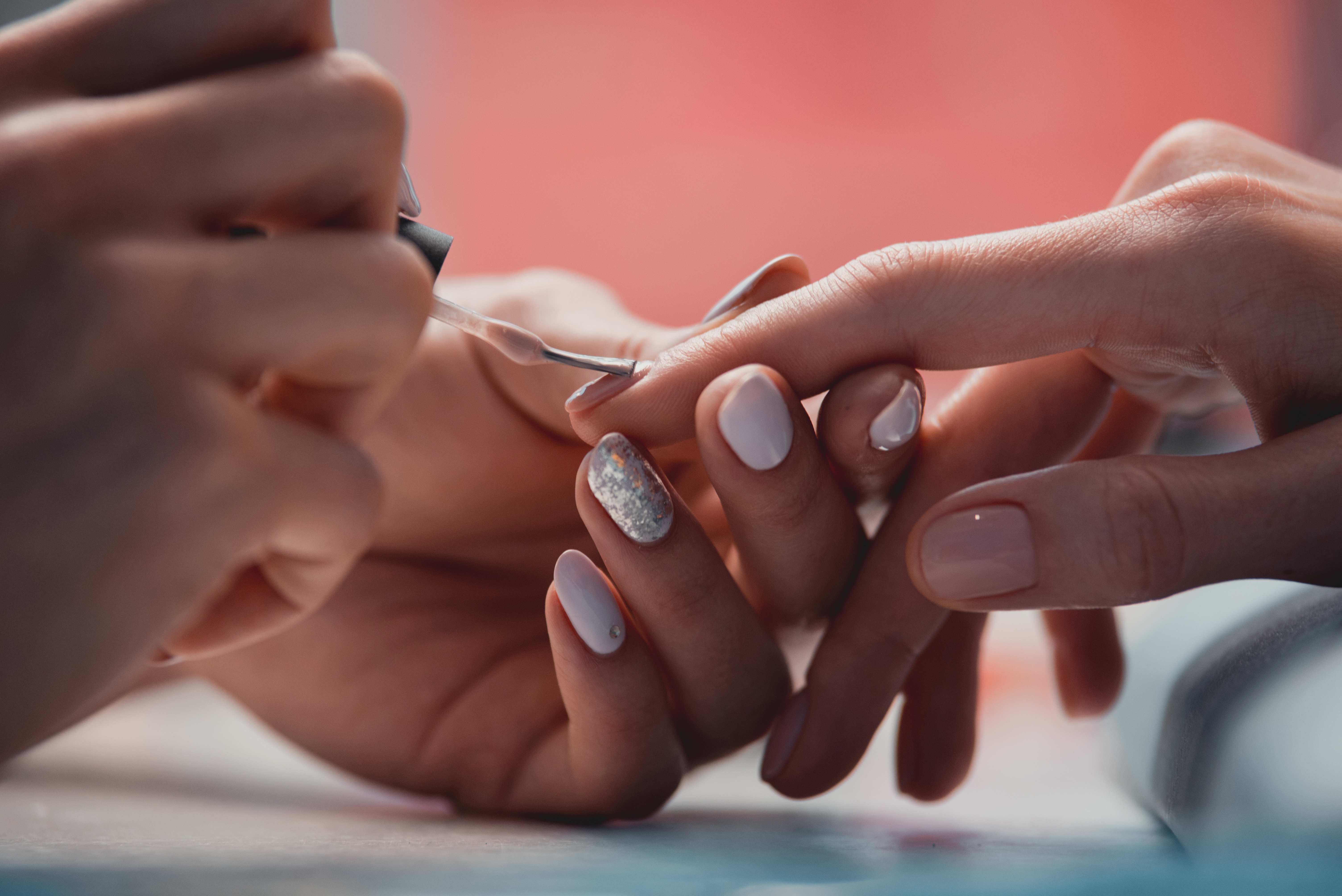 Manicurist painting nails 