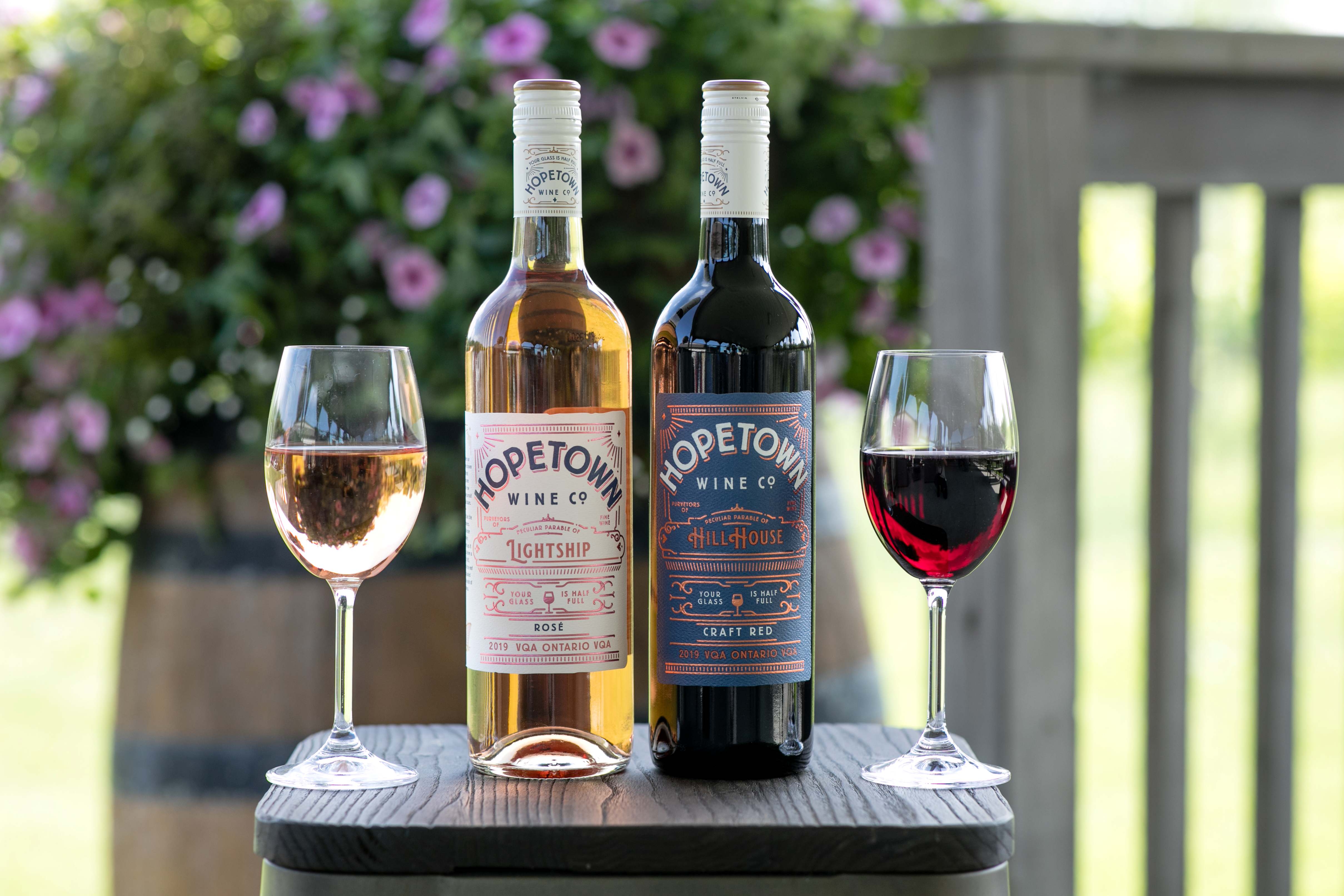 Two bottles and two glasses of Colio Hopetown wine